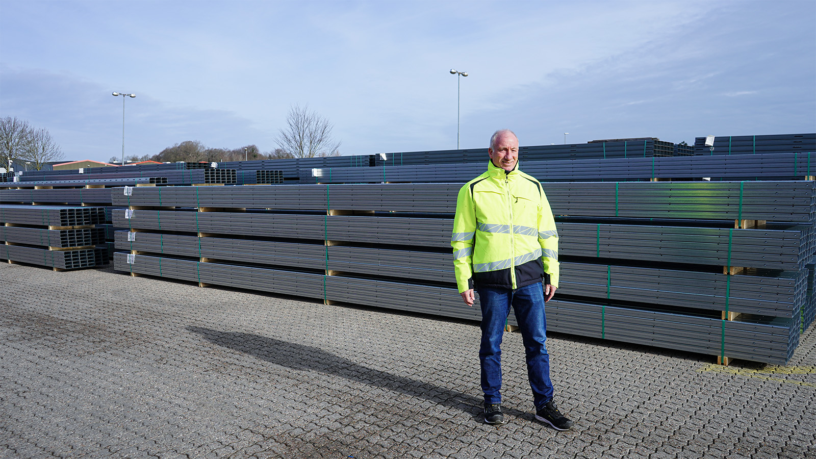 Ulrich, Sales Manager Solar, in front of steel profiles for a utility-scale solar project
